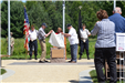 Ken Langmade and Clarence Anderson uncover the monument plaque
