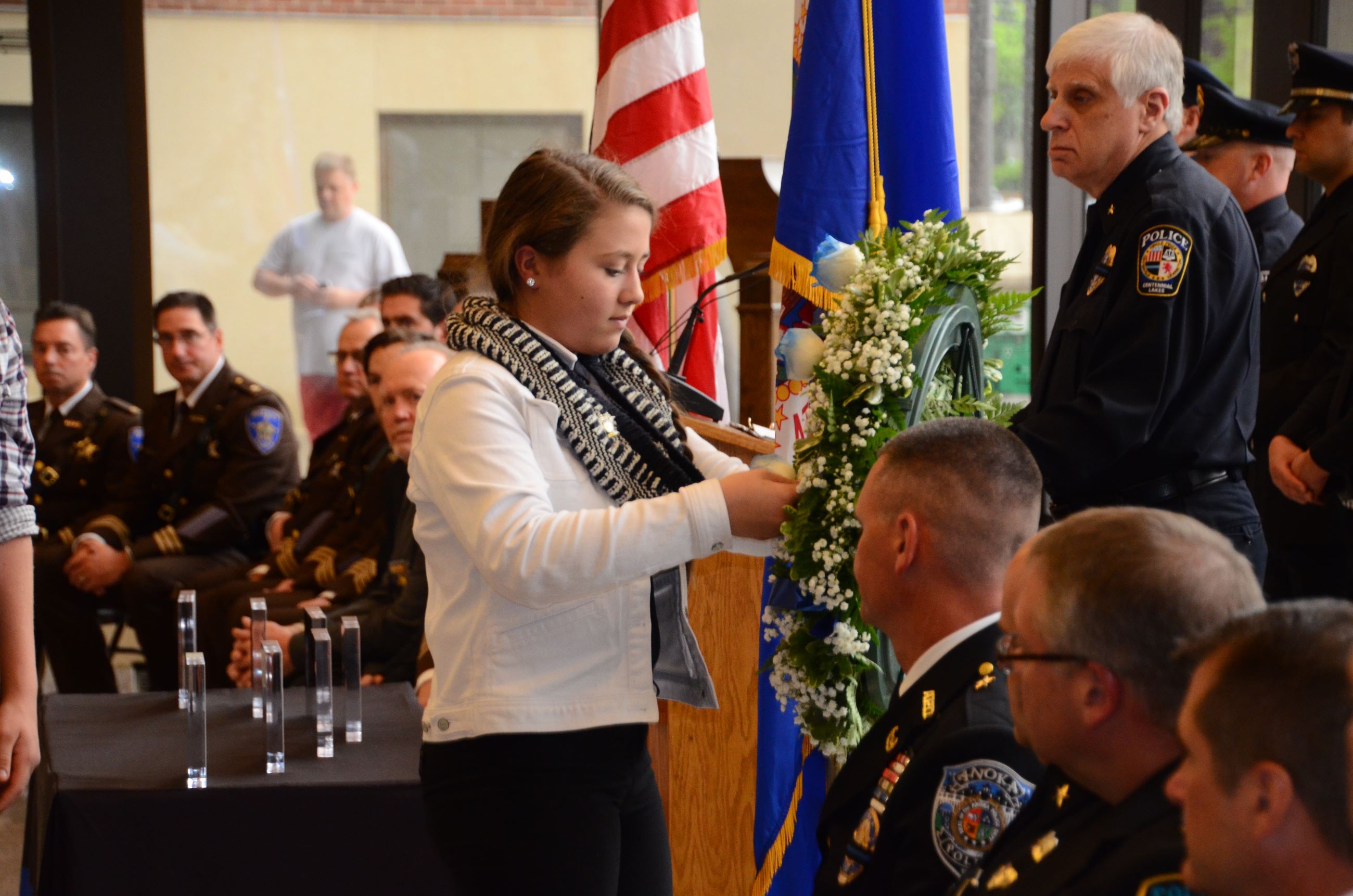 Family member places flower on wreath