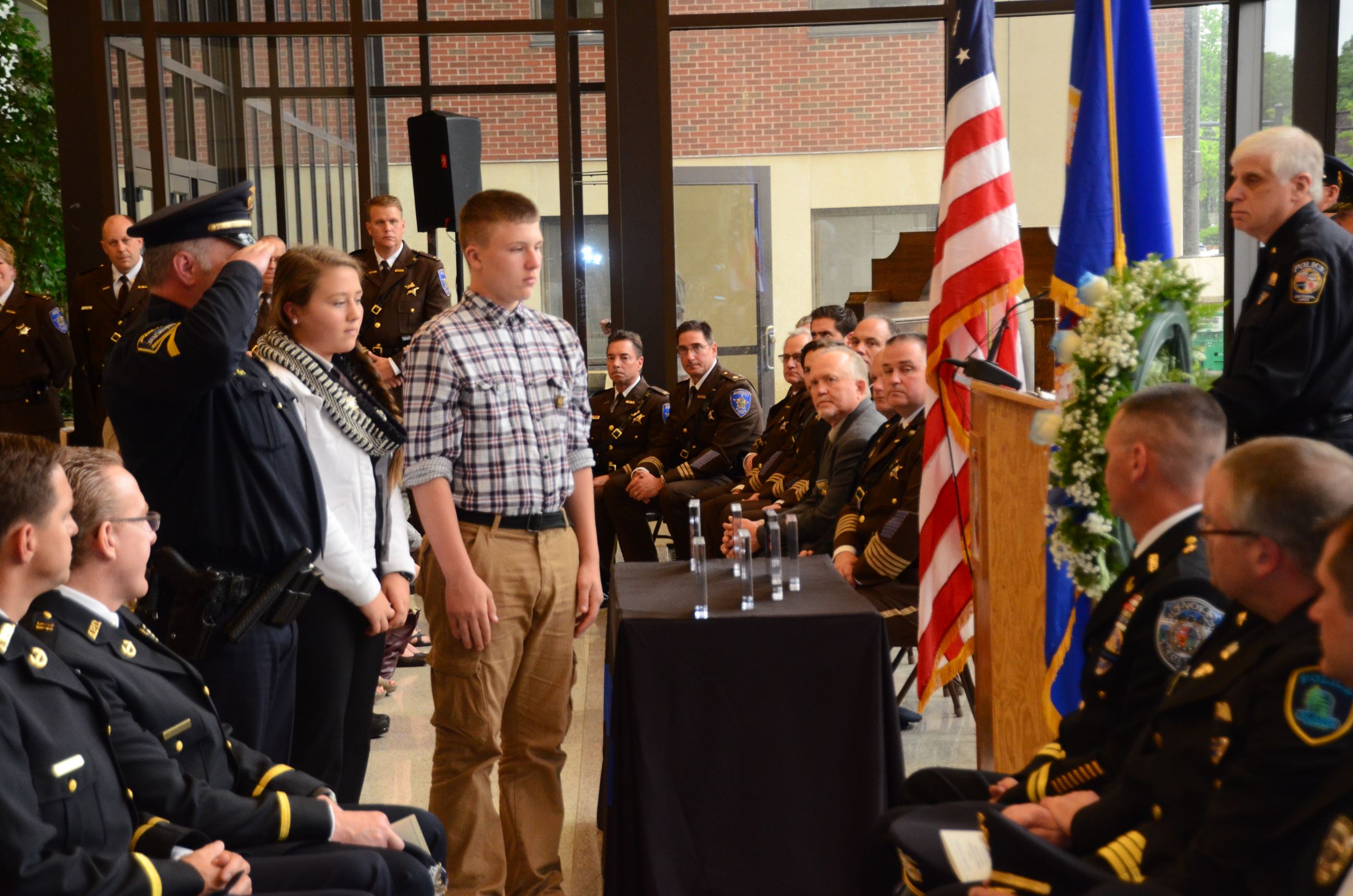 Family members stand before memorial wreath