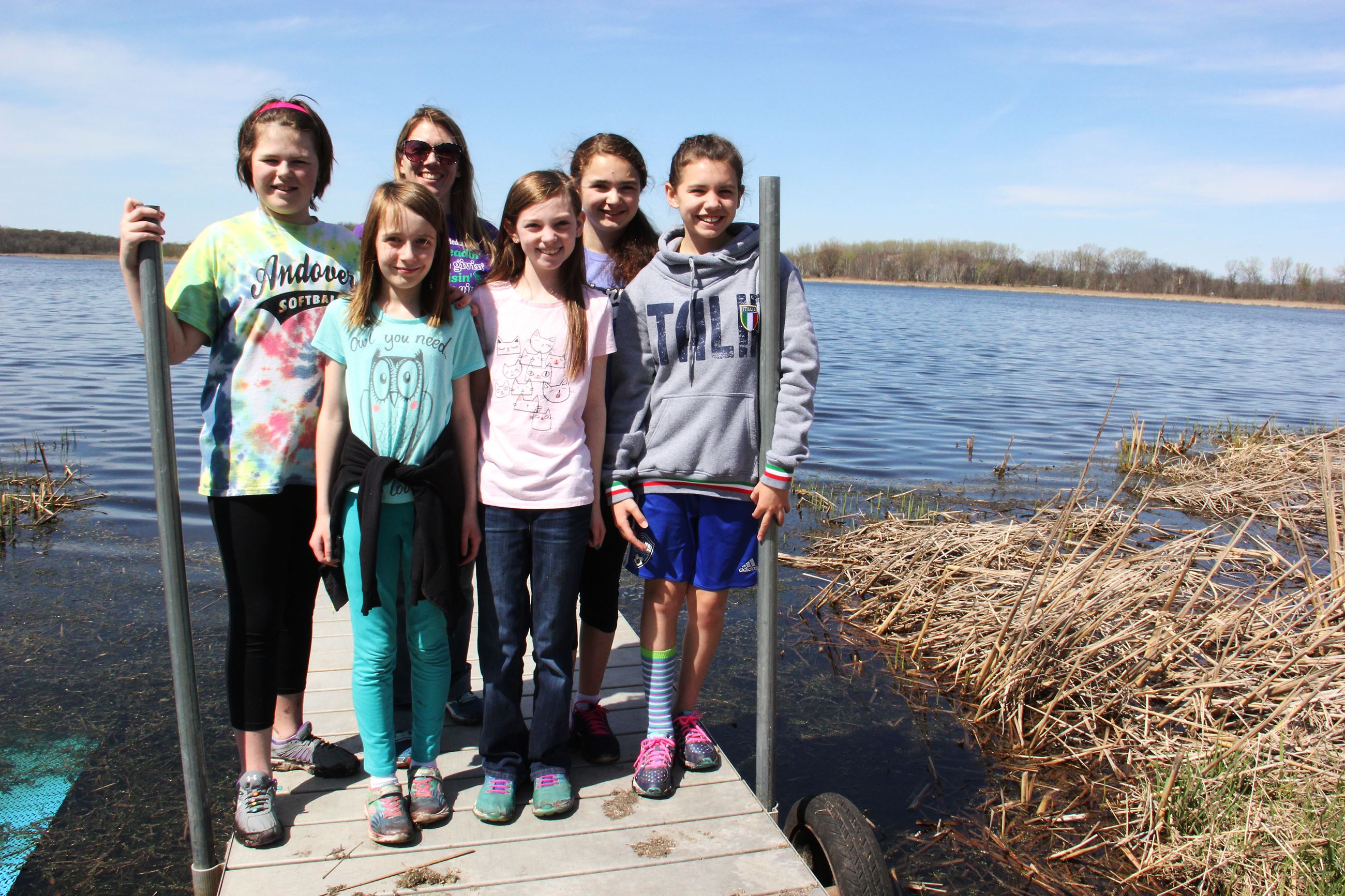 Children stand on a dock