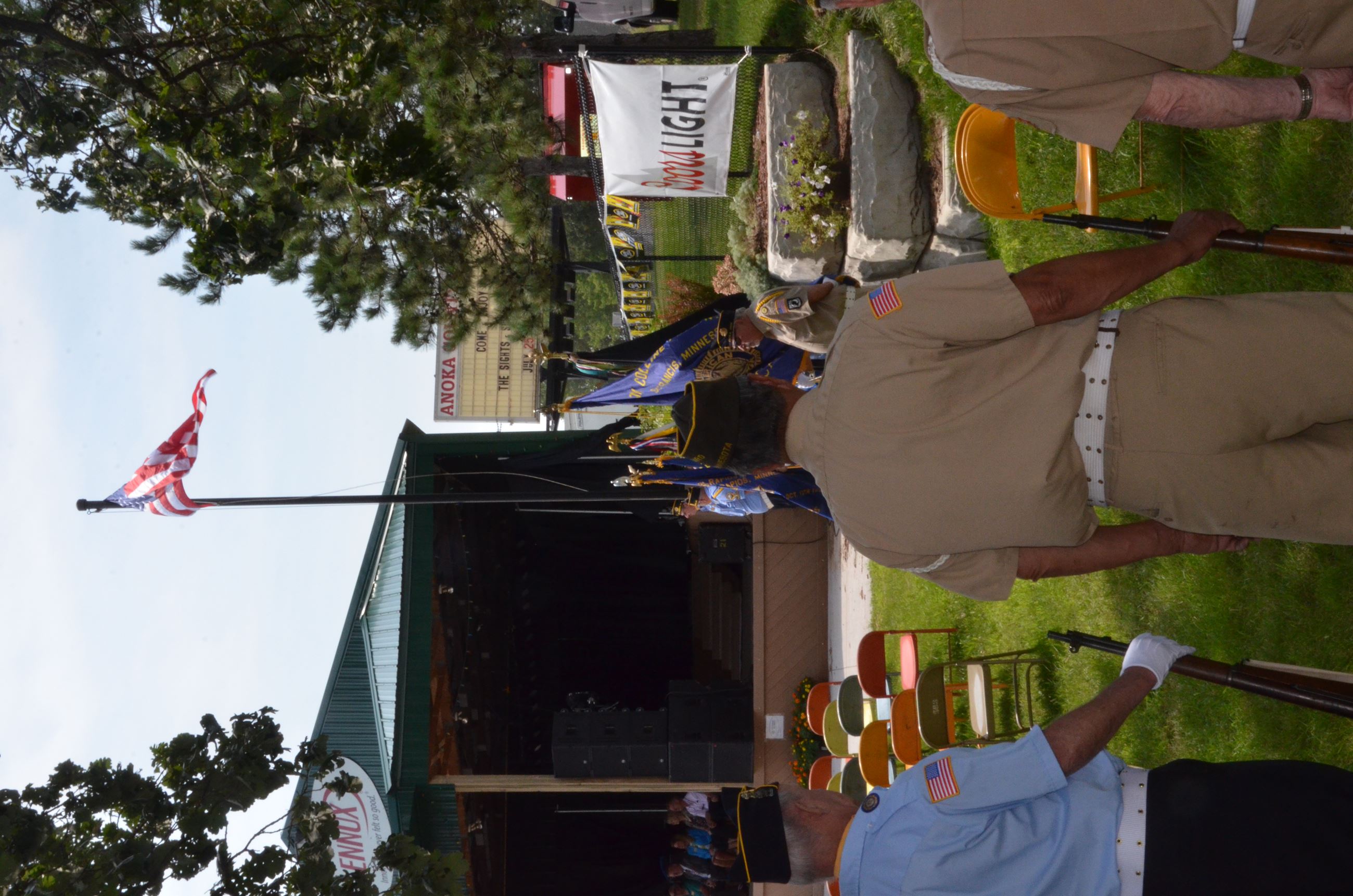 Honor guard stands before raised flag