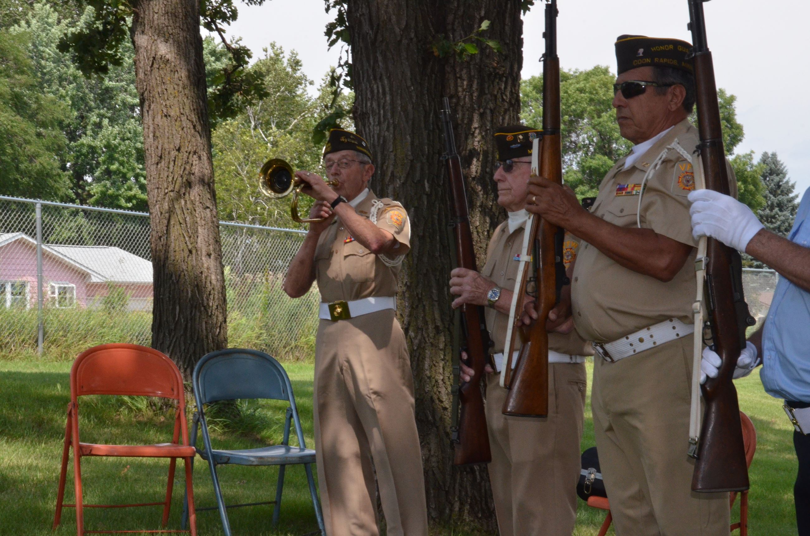 Honor guard member plays taps