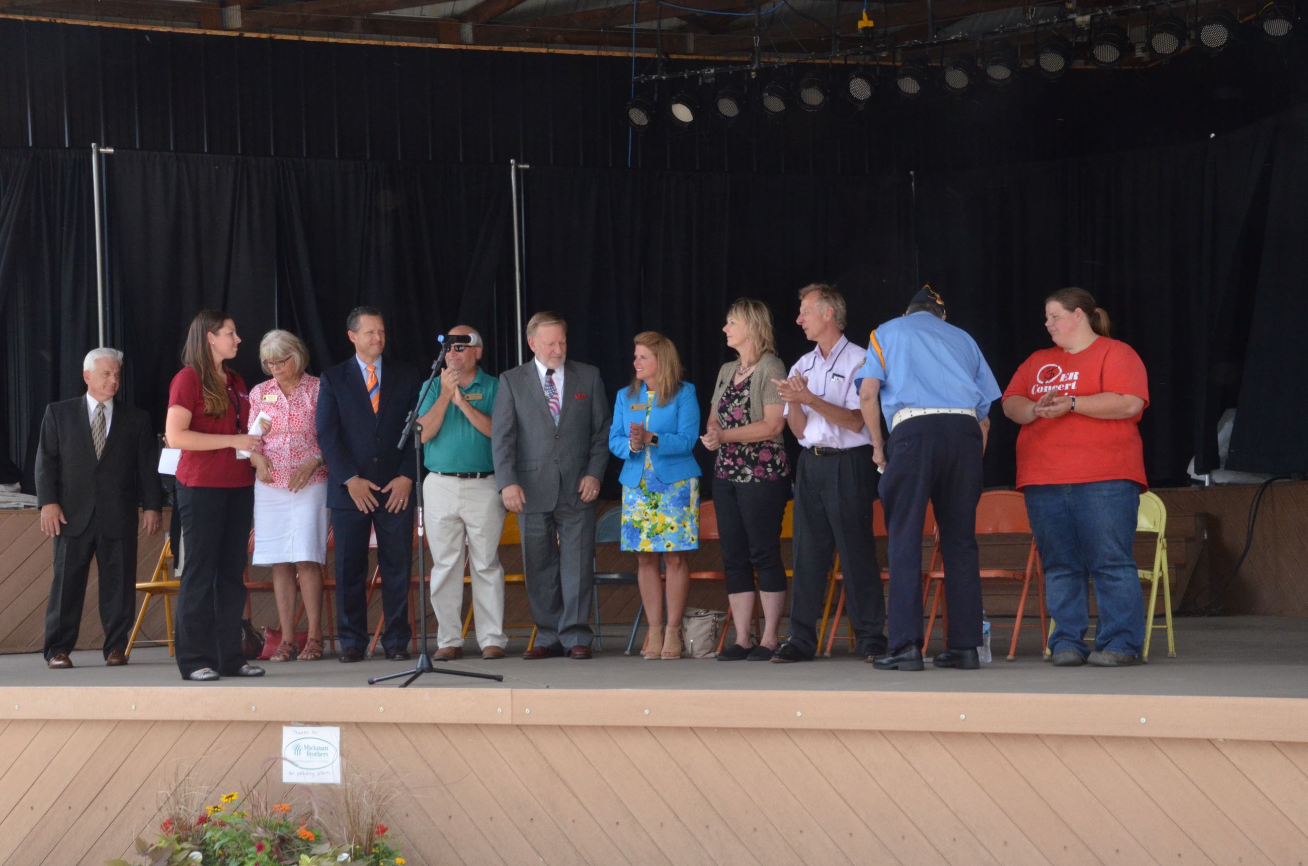 Public officials standing on stage