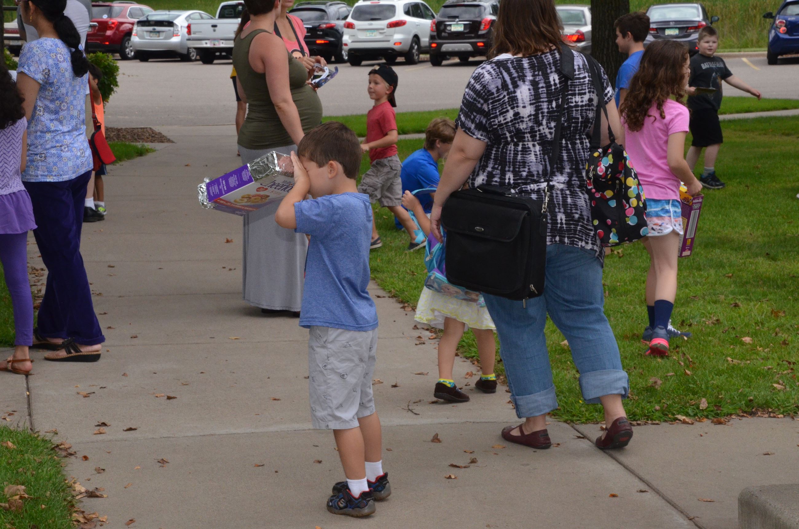 Child uses his new pin hole viewing box
