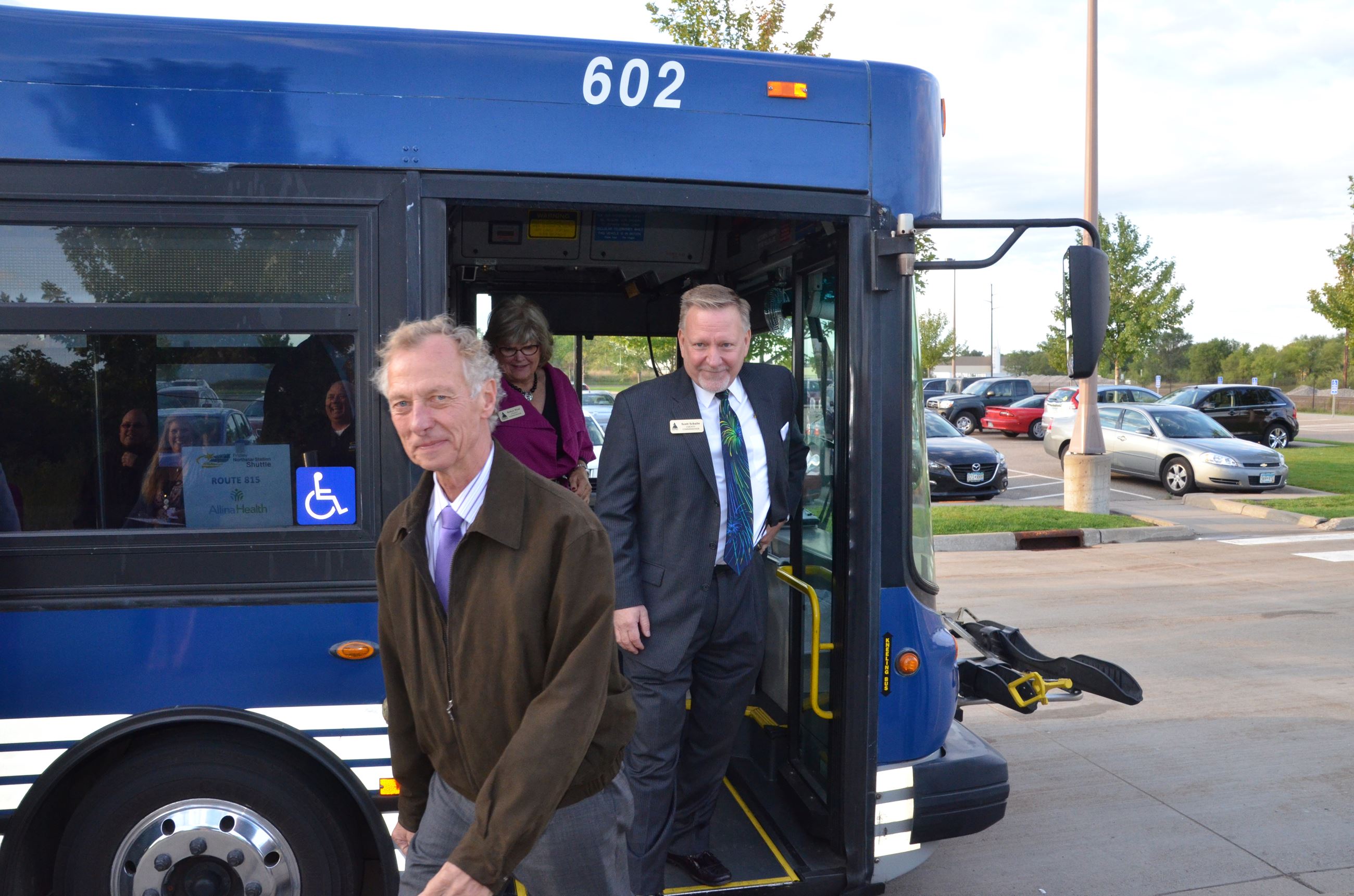 Commissioners Kordiak, Schulte, and West disembark from the shuttle bus
