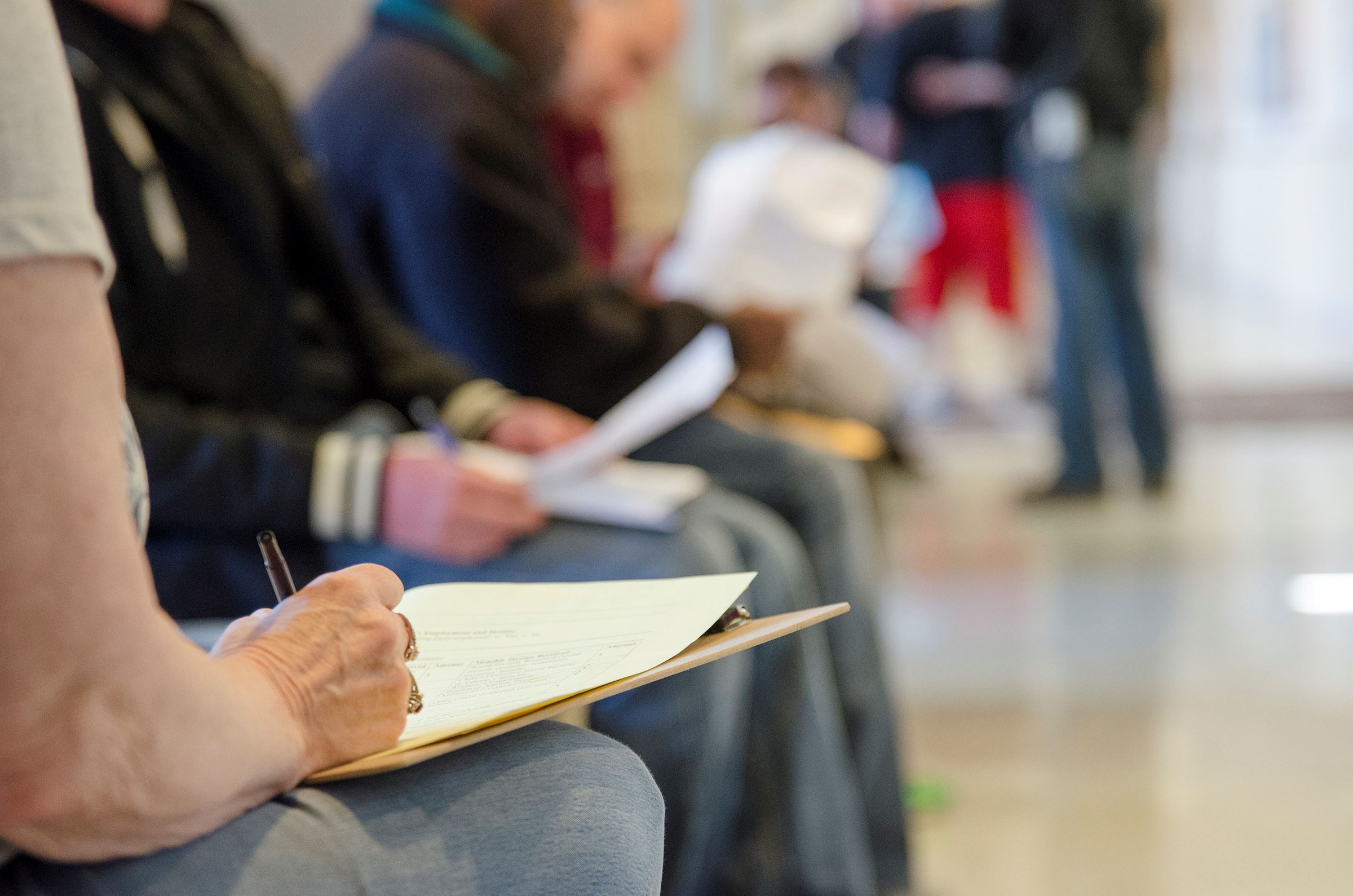 Law Day attendees fill out paperwork to resolve legal issues