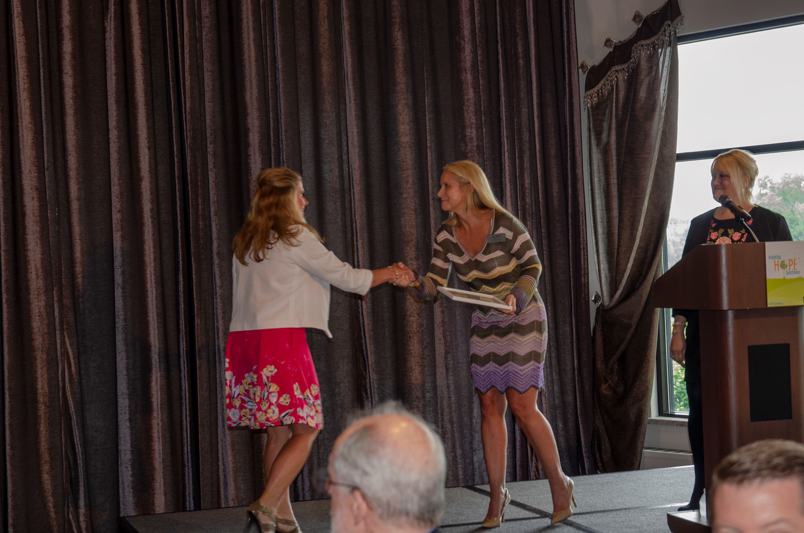 Commissioner Braastad accepting the Elected Officials award from Sue Woodward, HOPE 4 Youth Board Ch