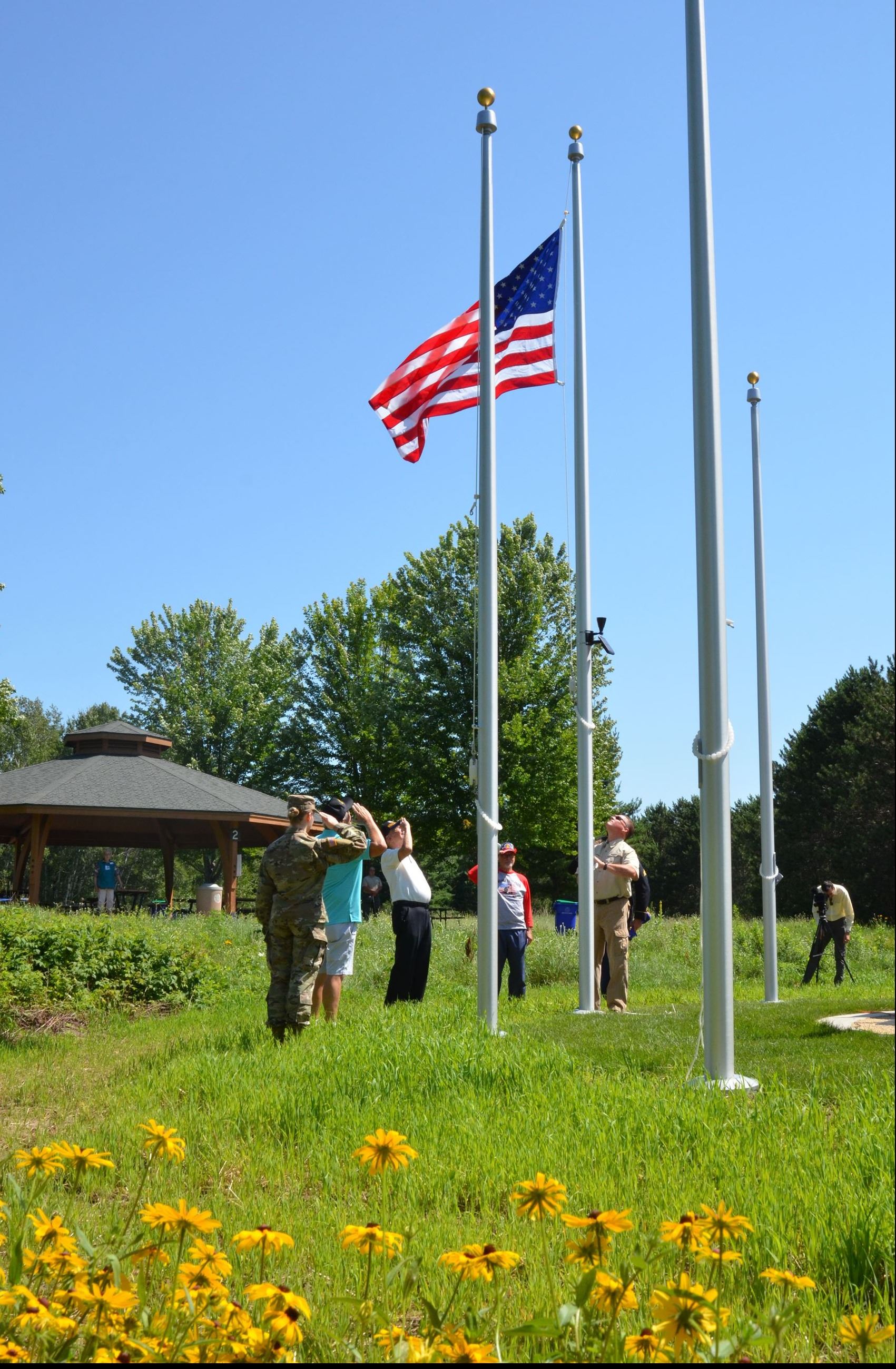 Veterans salute the raised flag