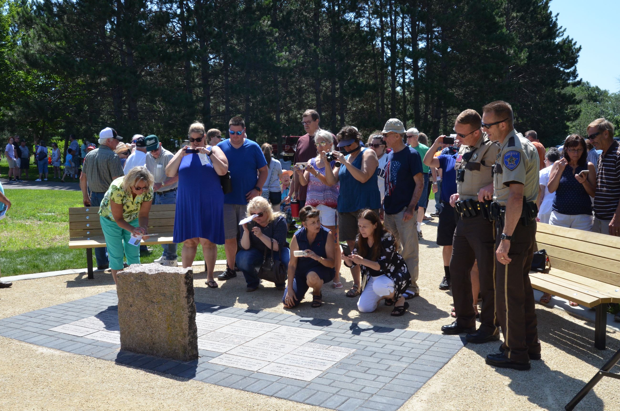Service attendees admire the new plaque