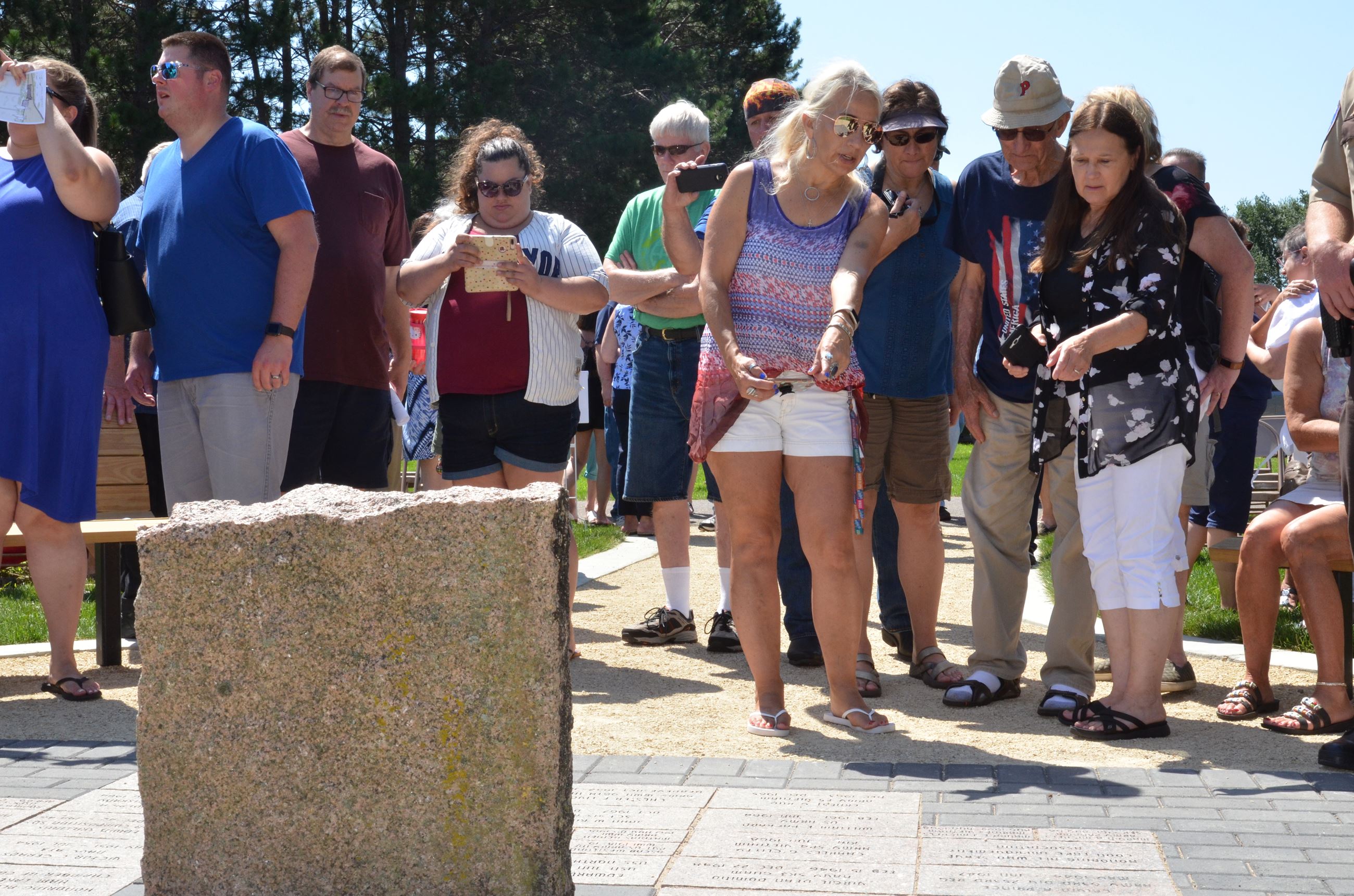 Service attendees admire the new plaque